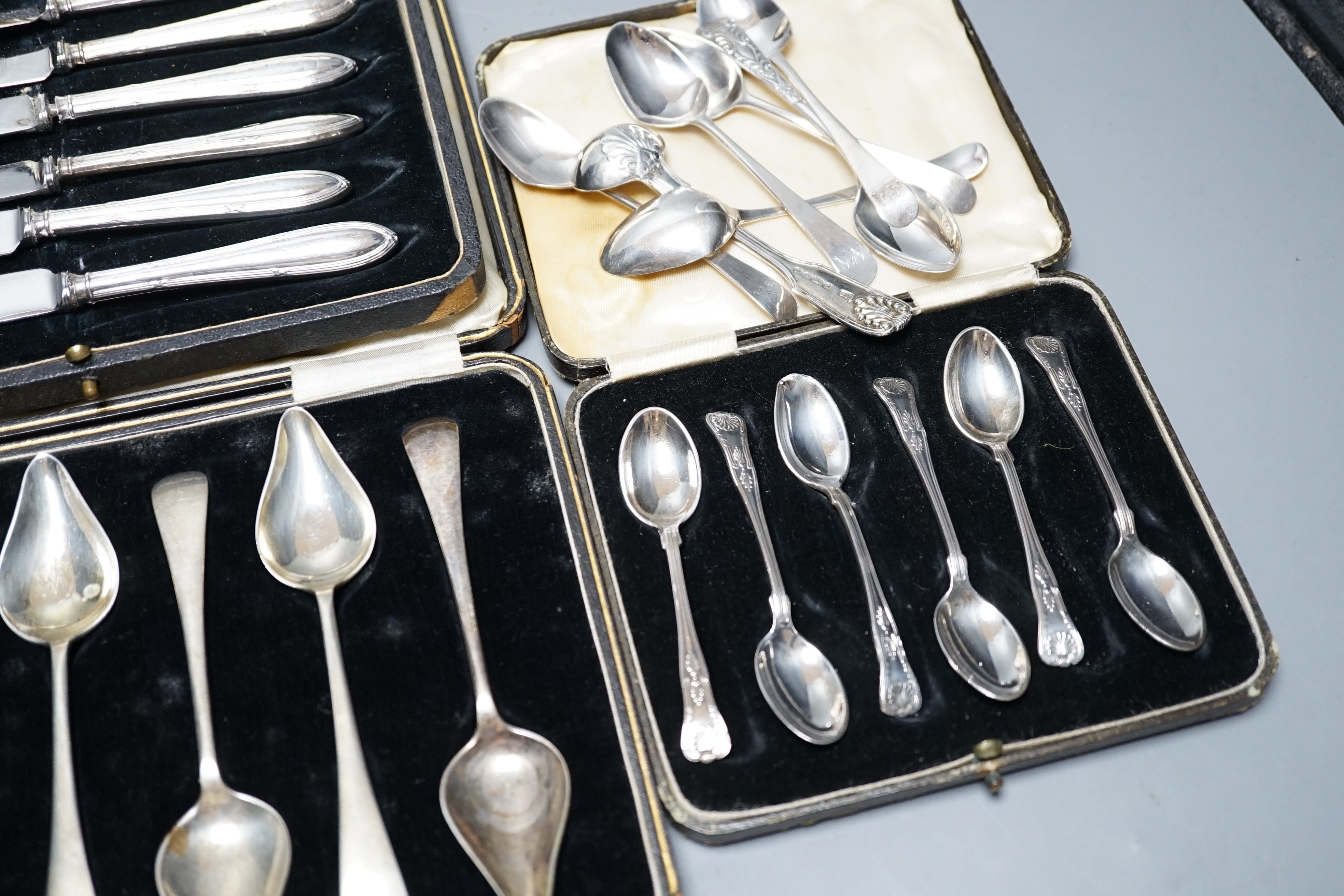 A case set of six George V silver Kings pattern coffee spoons, a cased set of six silver handled cake knives, three other incomplete silver sets and other minor silver flatware.